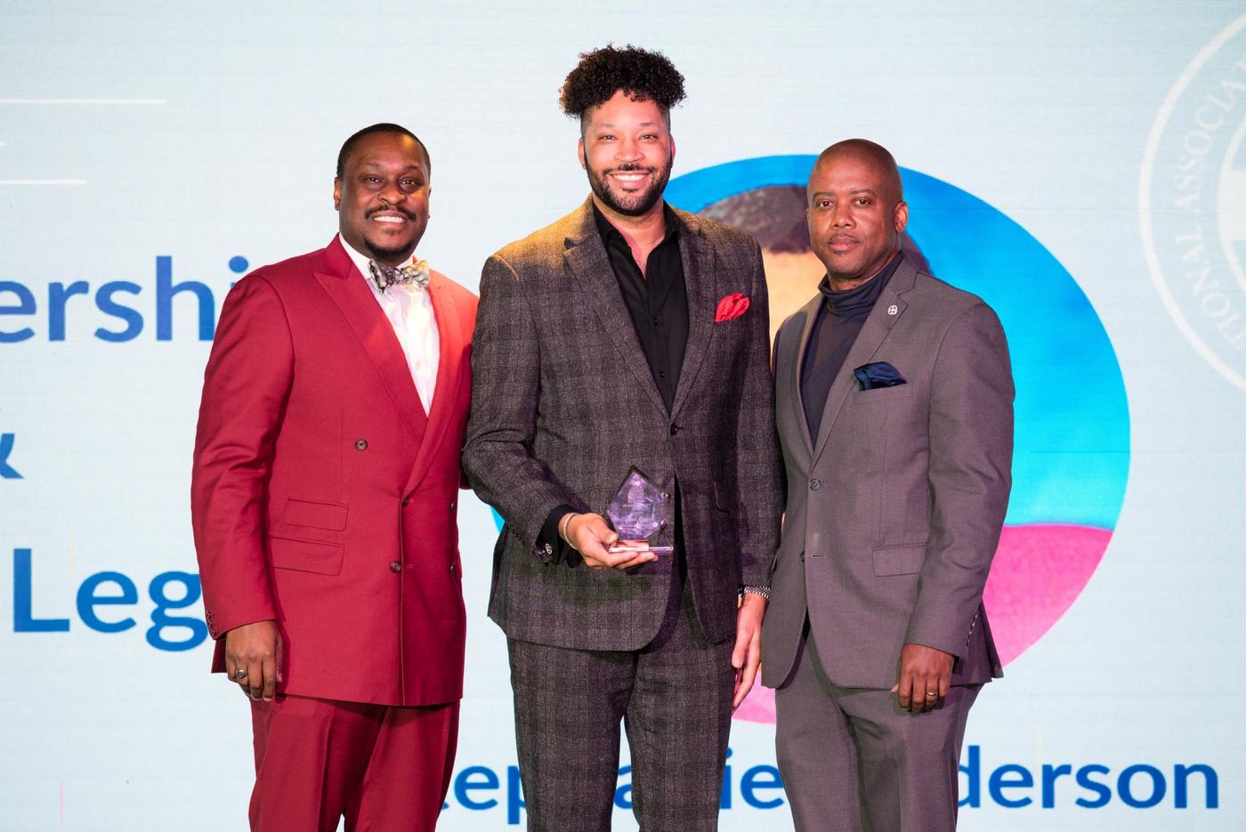 A Leadership & Legacy honoree receiving an award on stage